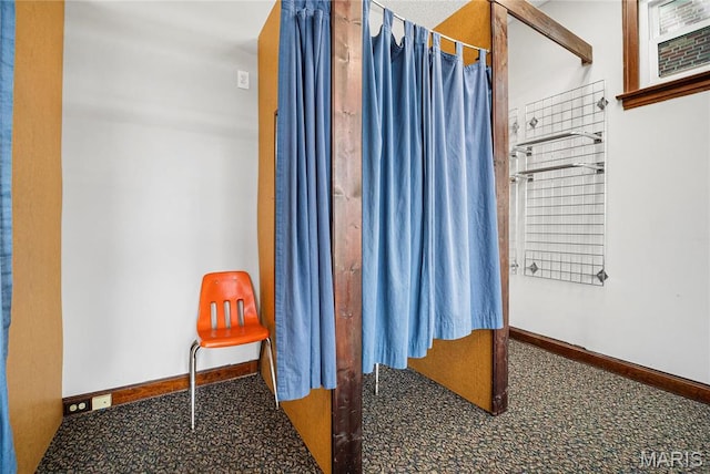 bathroom with baseboards and a shower with curtain