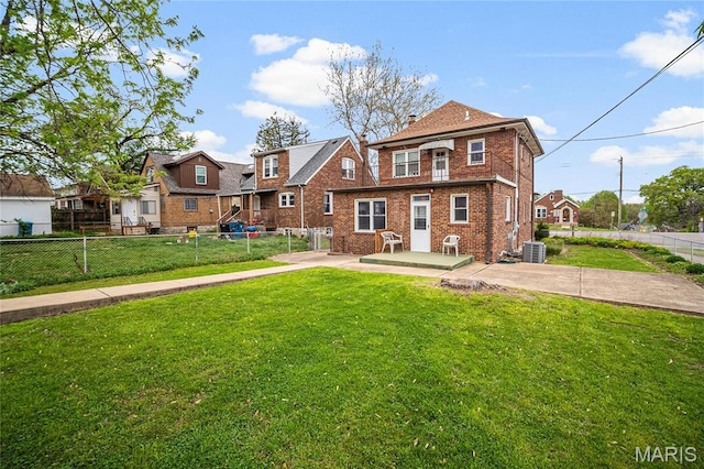 rear view of property with brick siding, central air condition unit, a residential view, a patio area, and a chimney
