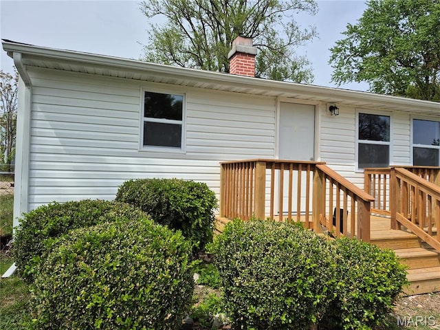 2205 Miracle Ave, Granite City, IL 62040 - doorway to property with a chimney and a wooden deck