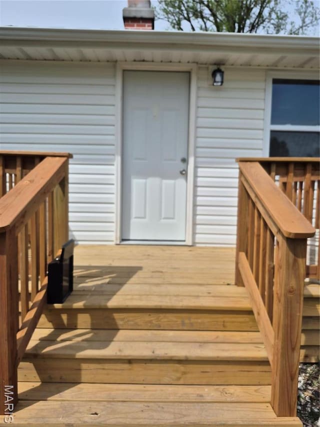 2205 Miracle Ave, Granite City, IL 62040 - view of exterior entry with a wooden deck and a chimney