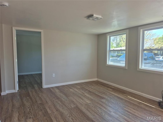 2205 Miracle Ave, Granite City, IL 62040 - empty room with dark wood-type flooring, a smoke detector, and baseboards