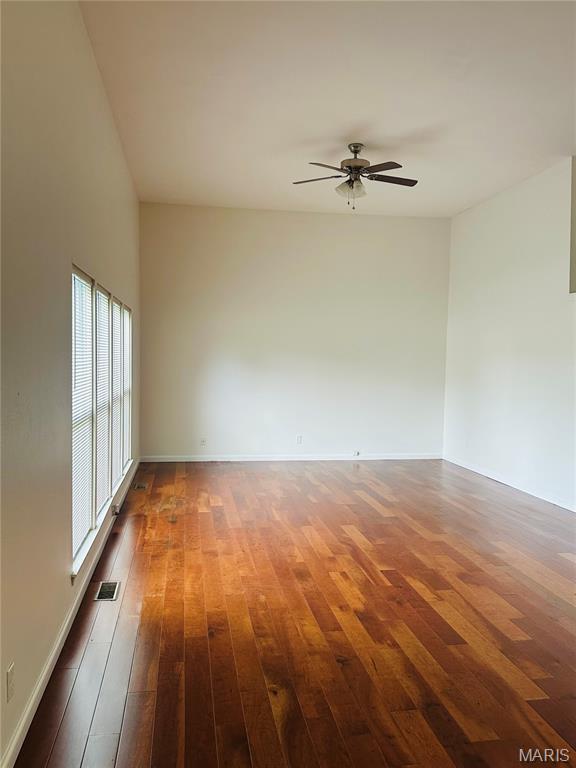 698 Carriage Ln, Hazelwood, MO 63042 - spare room with a ceiling fan, hardwood / wood-style floors, and baseboards