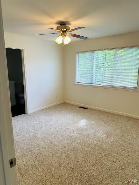 698 Carriage Ln, Hazelwood, MO 63042 - unfurnished room featuring baseboards, carpet flooring, and a ceiling fan