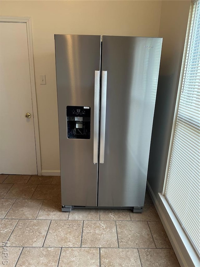 698 Carriage Ln, Hazelwood, MO 63042 - kitchen view of stainless steel fridge with ice dispenser and baseboards