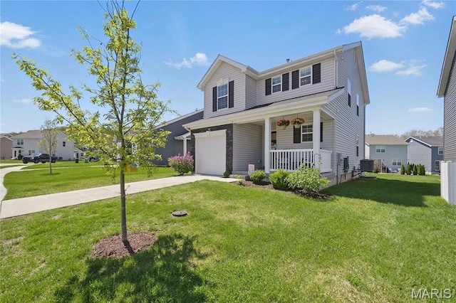 traditional home with a porch, concrete driveway, an attached garage, a front lawn, and central AC