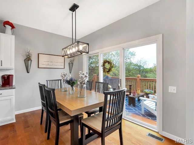 535 Vista Hills Ct, Eureka, MO 63025 - dining area featuring wood finished floors, baseboards, and a chandelier