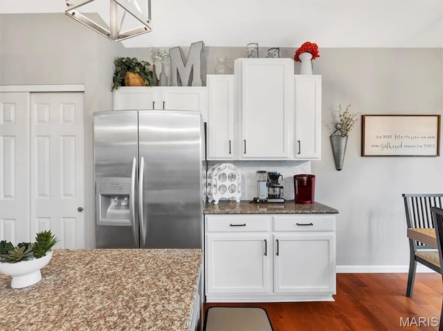 535 Vista Hills Ct, Eureka, MO 63025 - kitchen with stainless steel refrigerator with ice dispenser, dark stone countertops, white cabinetry, baseboards, and dark wood-style floors