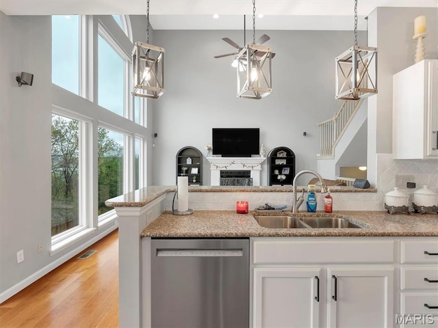 535 Vista Hills Ct, Eureka, MO 63025 - kitchen featuring stainless steel dishwasher, a sink, a towering ceiling, a ceiling fan, and white cabinetry