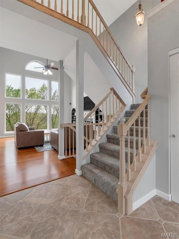 535 Vista Hills Ct, Eureka, MO 63025 - stairs with a towering ceiling, a ceiling fan, and baseboards