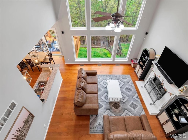 535 Vista Hills Ct, Eureka, MO 63025 - living area featuring a towering ceiling, ceiling fan, wood finished floors, and plenty of natural light