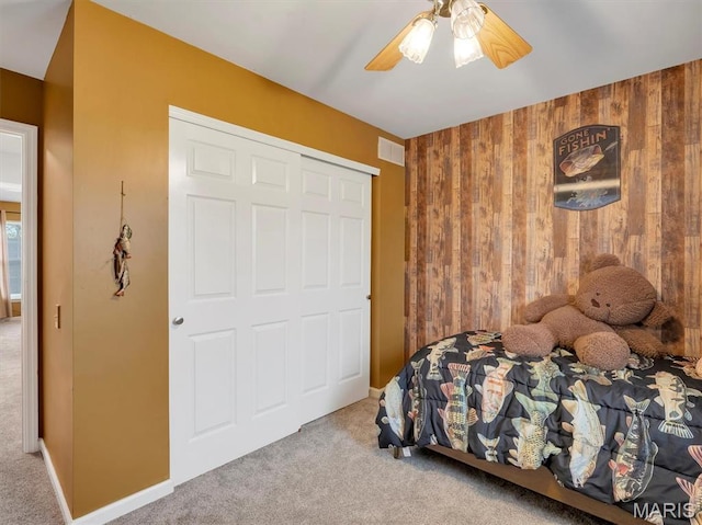 535 Vista Hills Ct, Eureka, MO 63025 - bedroom with wooden walls, carpet flooring, a closet, and a ceiling fan