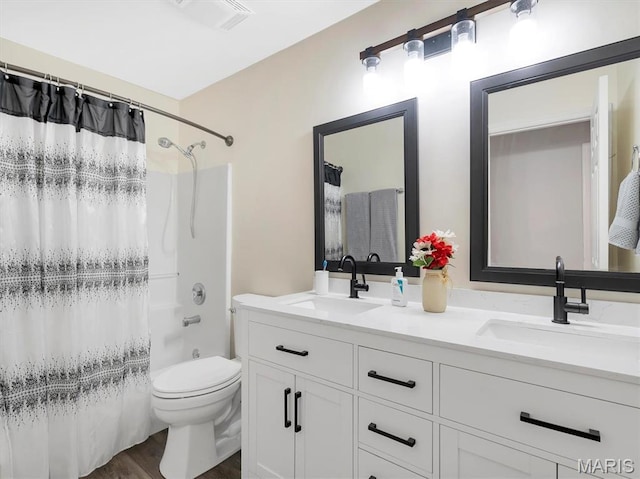 535 Vista Hills Ct, Eureka, MO 63025 - bathroom featuring wood finished floors, double vanity, toilet, and shower / bathtub combination with curtain