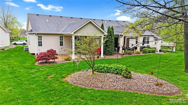 back of house featuring a patio area, a yard, and roof with shingles