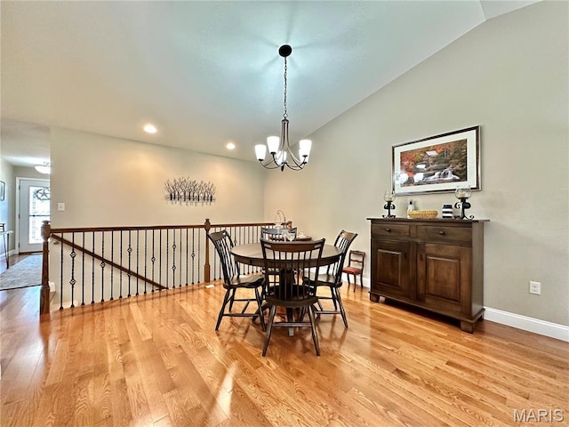 dining room with light wood-style flooring, vaulted ceiling, a chandelier, baseboards, and recessed lighting