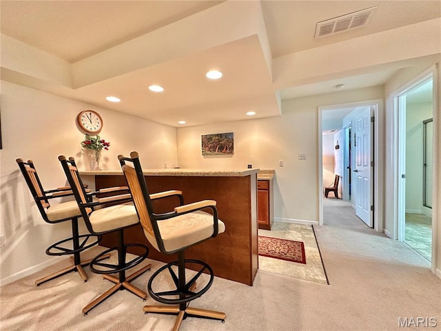 indoor dry bar featuring light carpet, recessed lighting, and baseboards