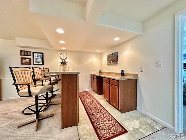 indoor dry bar featuring recessed lighting, baseboards, and light colored carpet