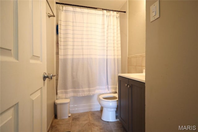 90 La Sierra Dr, Florissant, MO 63031 - bathroom featuring vanity, tile patterned floors, toilet, and shower / bath combo with shower curtain