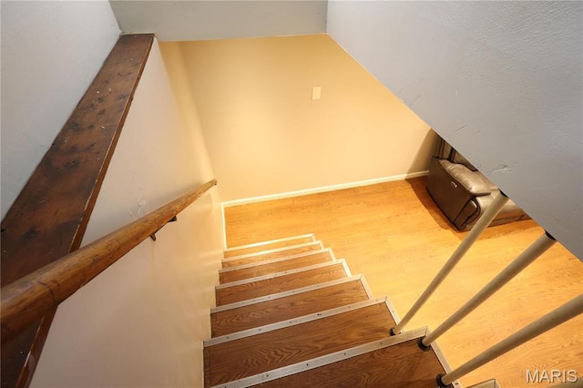 90 La Sierra Dr, Florissant, MO 63031 - stairway featuring wood finished floors, baseboards, and lofted ceiling
