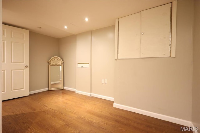 90 La Sierra Dr, Florissant, MO 63031 - below grade area with wood finished floors, baseboards, and recessed lighting