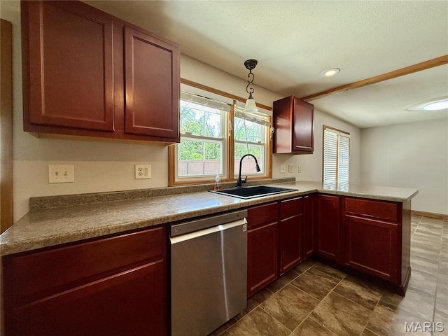 kitchen with stainless steel dishwasher, a sink, a peninsula, hanging light fixtures, and dark tile patterned flooring