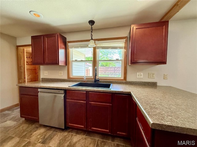 kitchen with dishwasher, a sink, hanging light fixtures, and dark brown cabinets