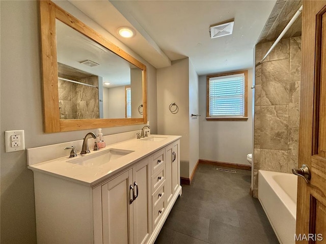 full bath featuring a shower, toilet, baseboards, double vanity, and a tub