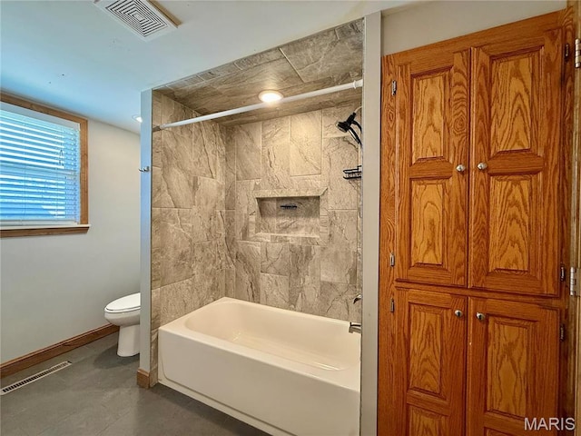 bathroom featuring toilet, washtub / shower combination, baseboards, and tile patterned floors