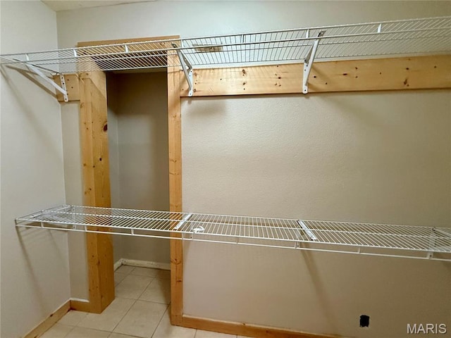 walk in closet with tile patterned floors