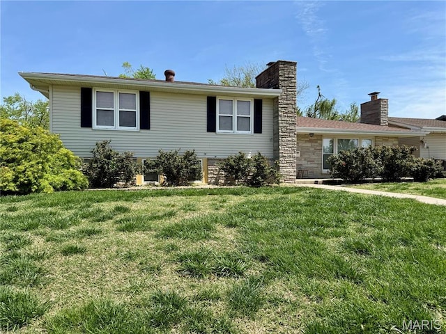 view of front of home with a front lawn and a chimney