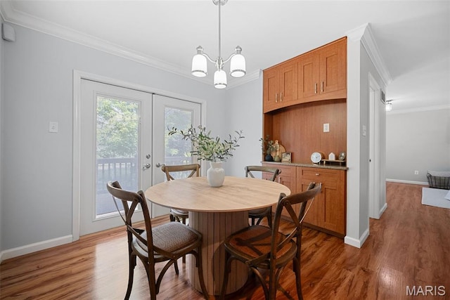 35 Heatherwood Ct, Ofallon, MO 63368 - dining room with crown molding, wood finished floors, french doors, and a chandelier