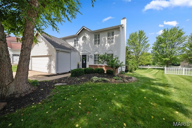 35 Heatherwood Ct, Ofallon, MO 63368 - rear view of house featuring a chimney, an attached garage, and concrete driveway