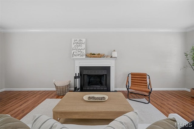 35 Heatherwood Ct, Ofallon, MO 63368 - living area featuring crown molding, wood finished floors, and a fireplace with flush hearth