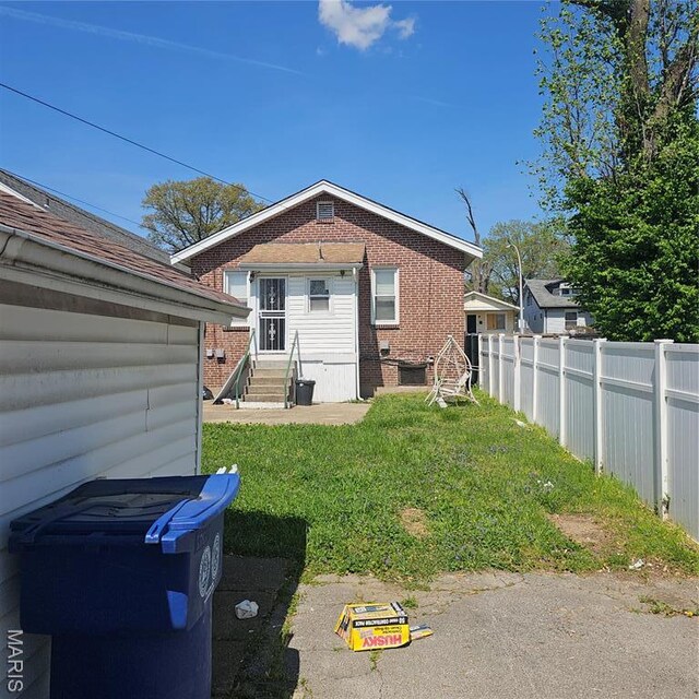 6336 Laura Ave, Saint Louis, MO 63136 - rear view of property featuring entry steps and brick siding