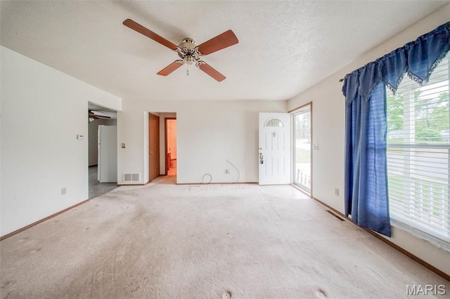 1407 Ramsey Place Rd, Rolla, MO 65401 - carpeted spare room with ceiling fan, baseboards, and a textured ceiling