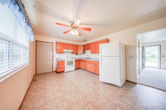 1407 Ramsey Place Rd, Rolla, MO 65401 - kitchen with white appliances, a sink, under cabinet range hood, light countertops, and baseboards