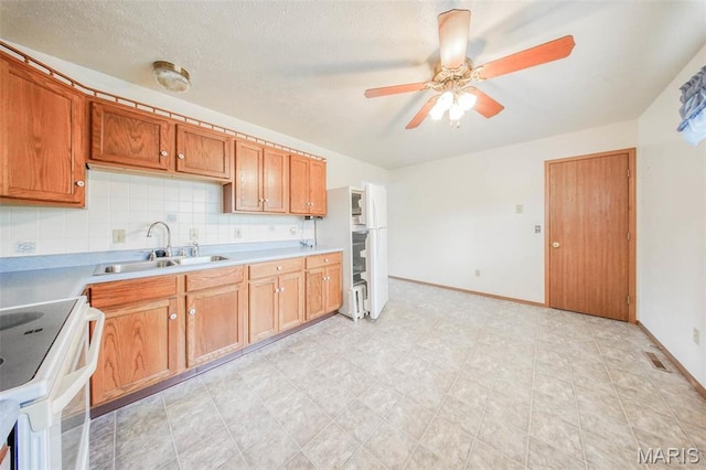 1407 Ramsey Place Rd, Rolla, MO 65401 - kitchen with a sink, white appliances, a ceiling fan, and baseboards