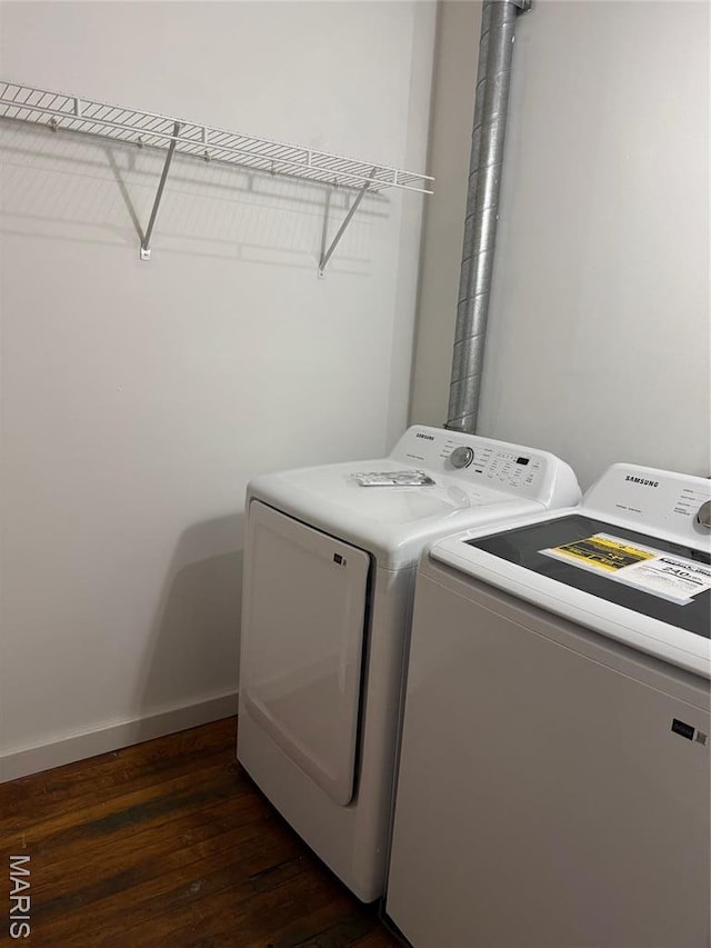 washroom featuring independent washer and dryer, dark wood-type flooring, and baseboards