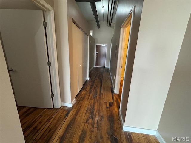 hallway with dark wood finished floors and baseboards
