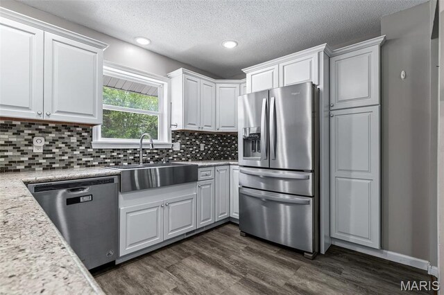 10179 Cherry Hill Ln, Potosi, MO 63664 - kitchen featuring appliances with stainless steel finishes, a sink, white cabinets, dark wood-style floors, and a textured ceiling