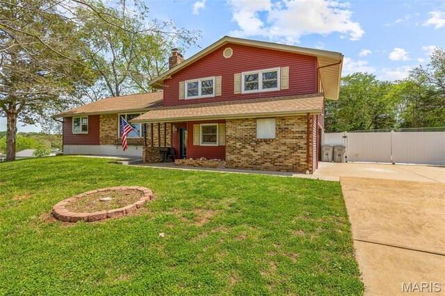 10179 Cherry Hill Ln, Potosi, MO 63664 - split level home with a chimney, a gate, brick siding, concrete driveway, and roof with shingles