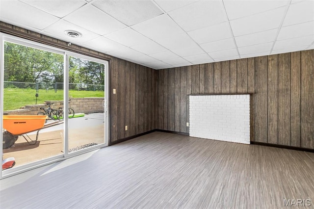 10179 Cherry Hill Ln, Potosi, MO 63664 - spare room featuring wood finished floors, a paneled ceiling, wood walls, and baseboards
