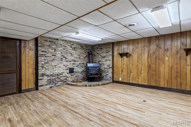 10179 Cherry Hill Ln, Potosi, MO 63664 - finished below grade area featuring wood finished floors, a wood stove, baseboards, a drop ceiling, and wood walls