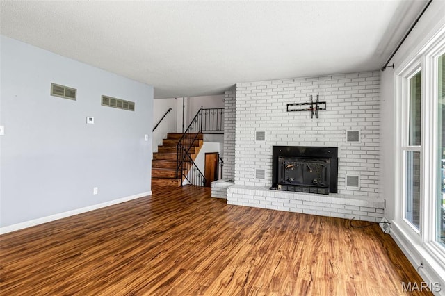 10179 Cherry Hill Ln, Potosi, MO 63664 - unfurnished living room featuring wood finished floors, a fireplace, baseboards, and stairway