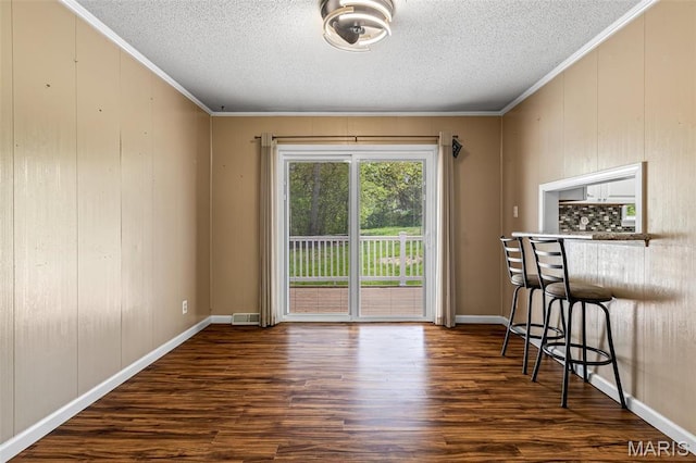 10179 Cherry Hill Ln, Potosi, MO 63664 - dining space with a textured ceiling, wood finished floors, crown molding, and baseboards