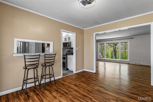 10179 Cherry Hill Ln, Potosi, MO 63664 - living area with ornamental molding, dark wood-style flooring, a textured ceiling, and baseboards