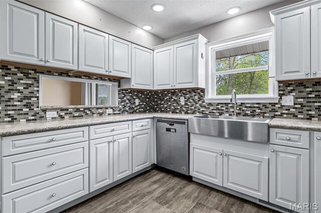 10179 Cherry Hill Ln, Potosi, MO 63664 - kitchen featuring stainless steel dishwasher, a sink, light countertops, white cabinetry, and dark wood finished floors