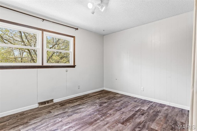 10179 Cherry Hill Ln, Potosi, MO 63664 - unfurnished room featuring a textured ceiling, wood finished floors, and baseboards