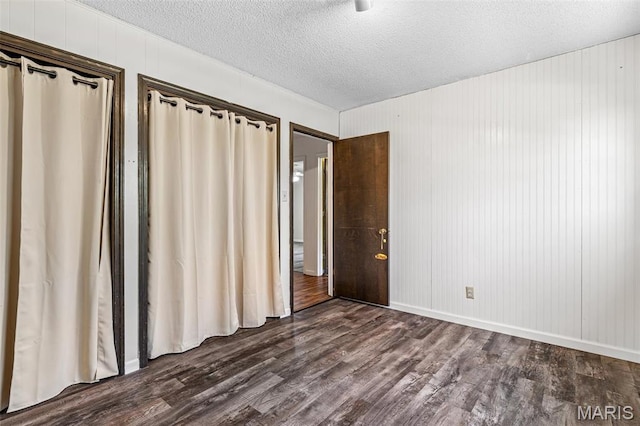 10179 Cherry Hill Ln, Potosi, MO 63664 - unfurnished bedroom featuring dark wood-type flooring and a textured ceiling