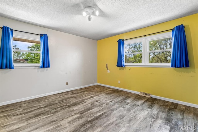 10179 Cherry Hill Ln, Potosi, MO 63664 - spare room featuring wood finished floors, a textured ceiling, and baseboards