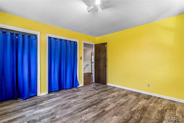 10179 Cherry Hill Ln, Potosi, MO 63664 - unfurnished bedroom featuring wood finished floors, baseboards, and a textured ceiling